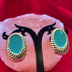 Goldtone green enameled clip-on earrings.